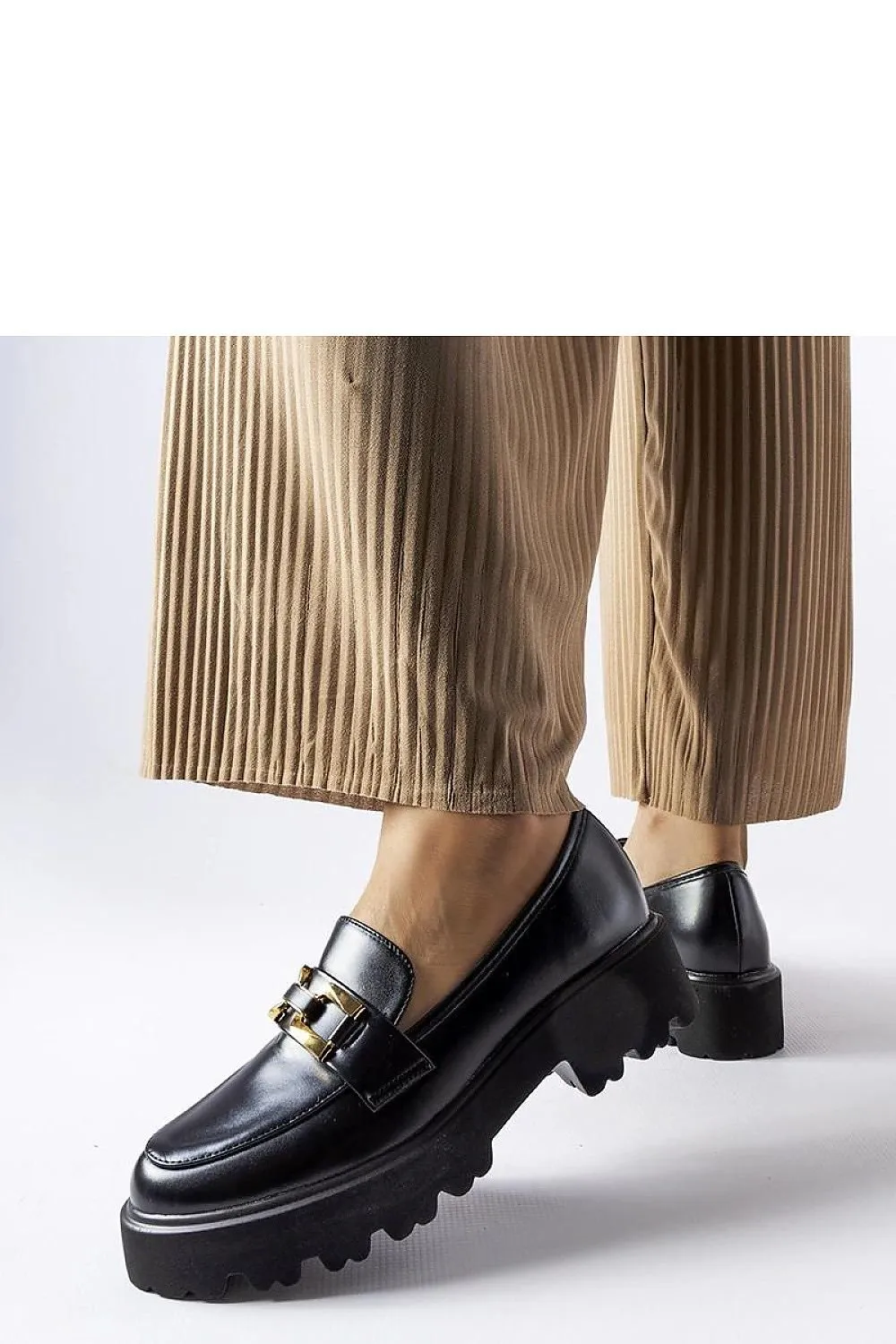 Black moccasins decorated with a buckle