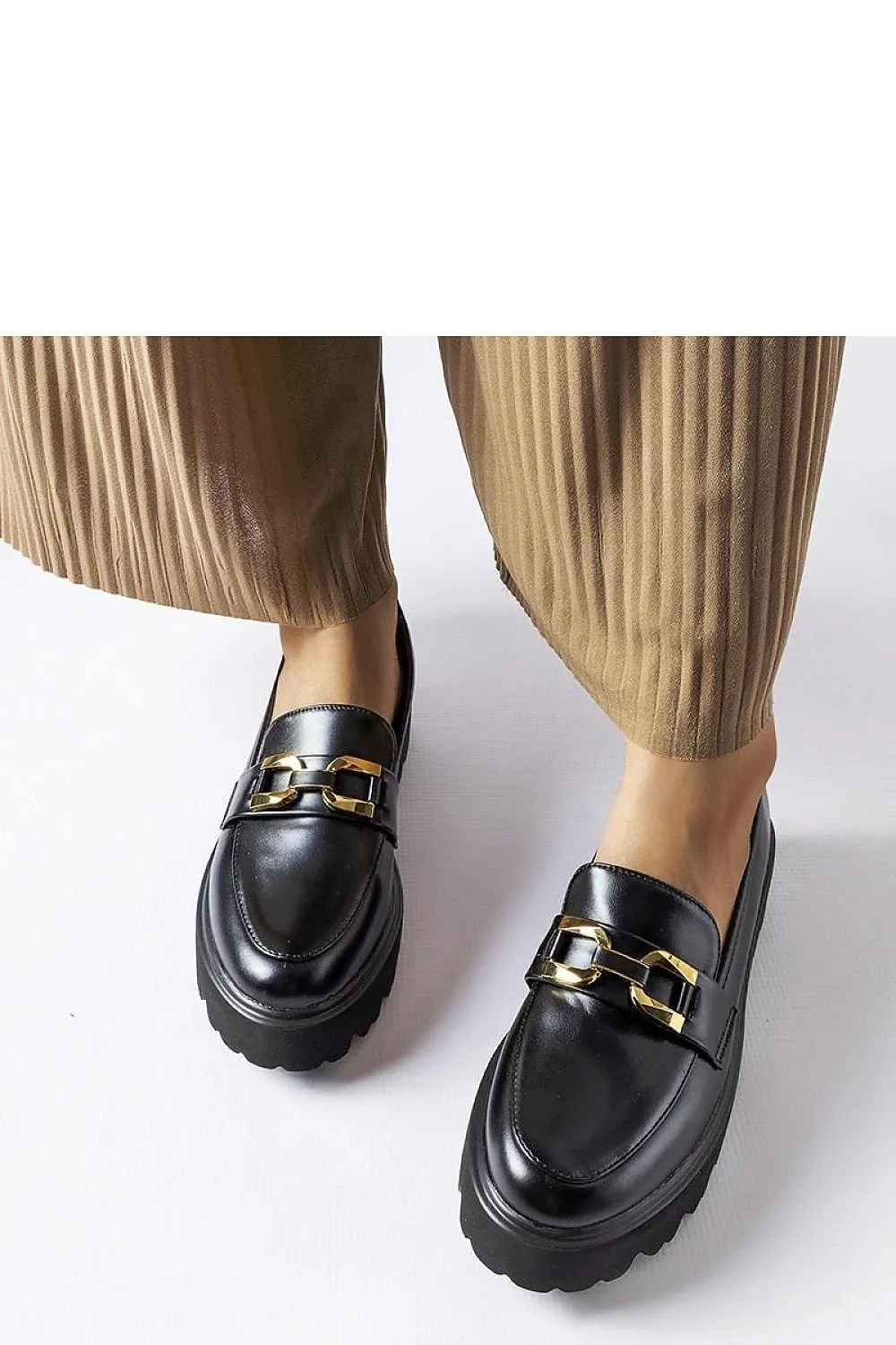 Black moccasins decorated with a buckle